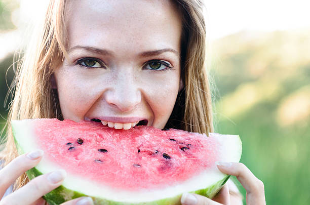 istock Carefree woman with watermelon 166768941