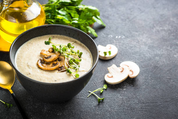 istock Mushroom Soup in craft bowl on dark stone table. 1667692825
