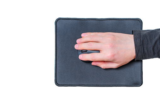 Top view of a male hand using a computer mouse on a brand new mouse pad isolated on white.