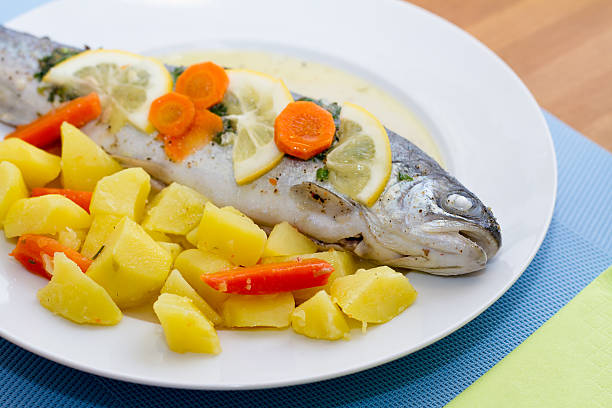 istock Trout fish with lemon slices and boiled potatoes 166769877