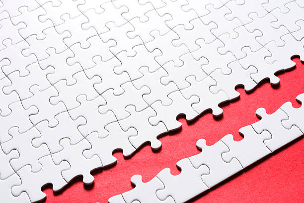 istock Blank white jigsaw puzzle against red background with copy space 166769969