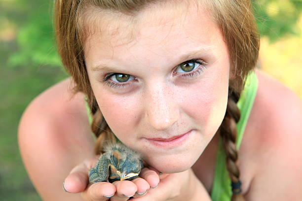 istock Girl Holding Baby Robin 166771148