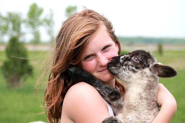 istock Girl Holding Lamb 166771220
