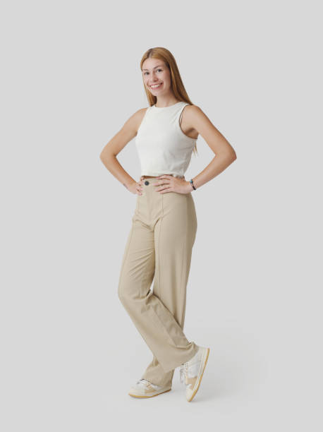 istock Young woman standing and looking at camera 1667724435