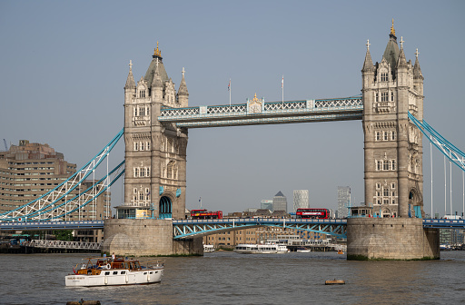 London, UK: Tower Bridge, a famous landmark in London. The bridge crosses the River Thames near to the Tower of London and was completed in 1894. With red buses.