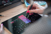 Data analysis. A woman examining financial graphs, charts, metrics and other information digital tablet