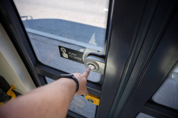 istock A man pointing / pushing on the button to open doors of a public transportation vehicle. First person view 1667757468