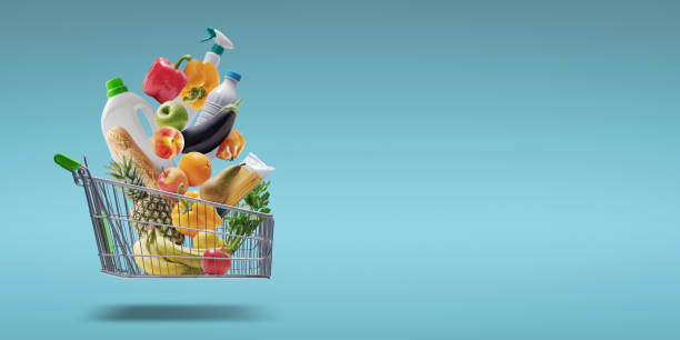 istock Groceries and goods falling in a shopping cart 1667763940
