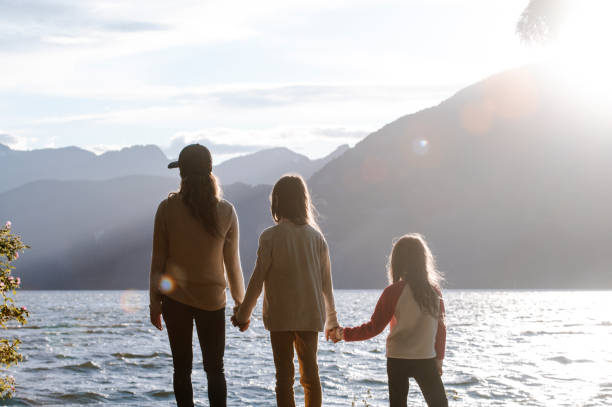 istock Mother and daughters bonding in nature 1667767342