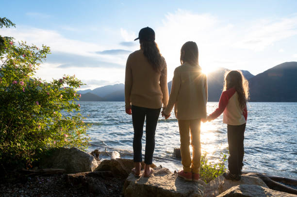 istock Mother and daughters bonding in nature 1667767679