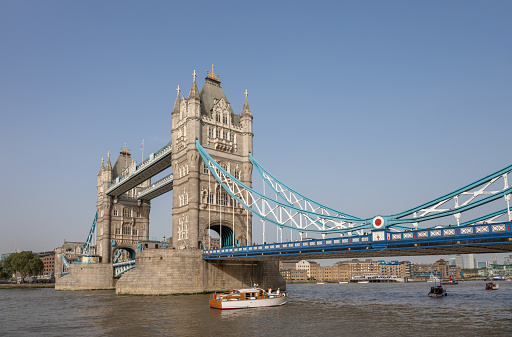 London, UK: Tower Bridge, a famous landmark in London. The bridge crosses the River Thames near to the Tower of London and was completed in 1894. Side view.