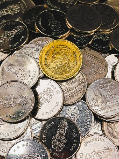 istock Gold coin on silver coins 1667789557