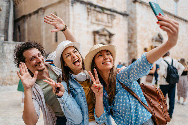 istock Three Young Friends Taking Selfies On The Town Square In Dubrovnik 1667790091