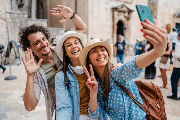 istock Three Young Friends Taking Selfies On The Town Square In Dubrovnik 1667794417