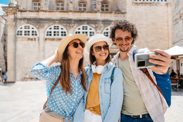 istock Three Young Friends Taking Selfies On The Town Square In Dubrovnik 1667800402