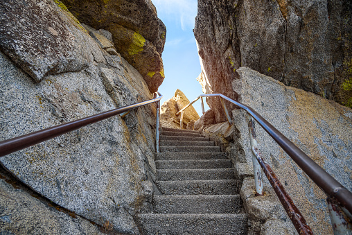 Narrow flight of steps cut through rock on the top of a mountain on a sunny autumn day. Moro Rock, Sequoia National Park, CA, USA.