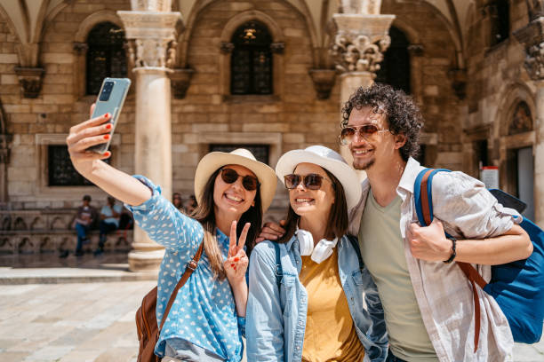istock Three Young Friends Taking Selfies On The Town Square In Dubrovnik 1667805200