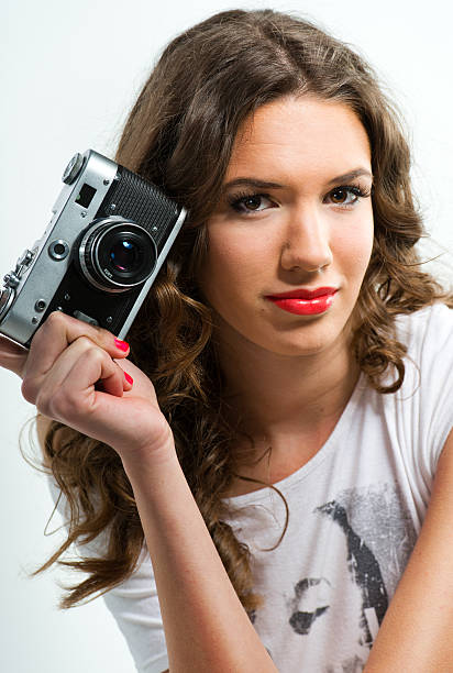 istock Woman holding an old camera 166780544