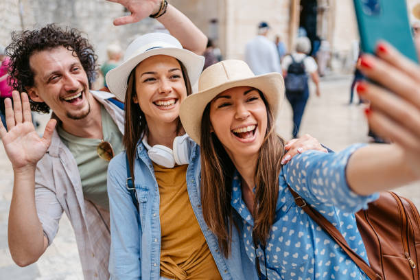 istock Three Young Friends Taking Selfies On The Town Square In Dubrovnik 1667806815
