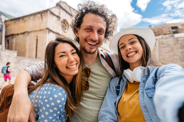 istock Three Young Friends Taking Selfies On The Town Square In Dubrovnik 1667811105