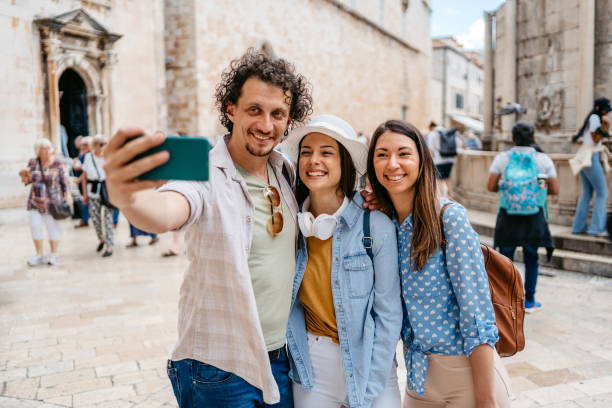 istock Three Young Friends Taking Selfies On The Town Square In Dubrovnik 1667812184