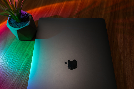 Laptop back with colorful lights - Apple Macbook pro computer\n| Abu Dhabi, UAE, August 27, 2023