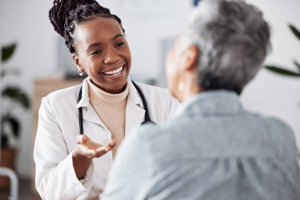 sonríe, mujer negra o médico que consulta a un paciente en una reunión en el hospital para obtener comentarios o apoyo de atención médica. feliz, médico o enfermera con una persona madura hablando o hablando de los resultados de las pruebas o consejo - patient medical exam meeting doctor fotografías e imágenes de stock