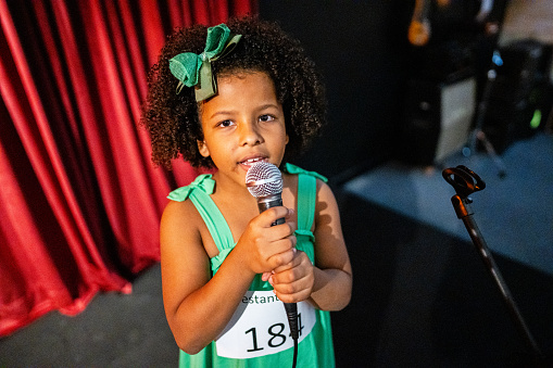 Portrait of a girl singing in a music contest