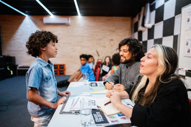 istock Boy talking to judges in a contest music 1667839734