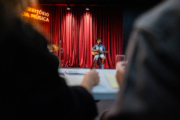 Boy singing and playing a guitar (cavaco) in a music contest
