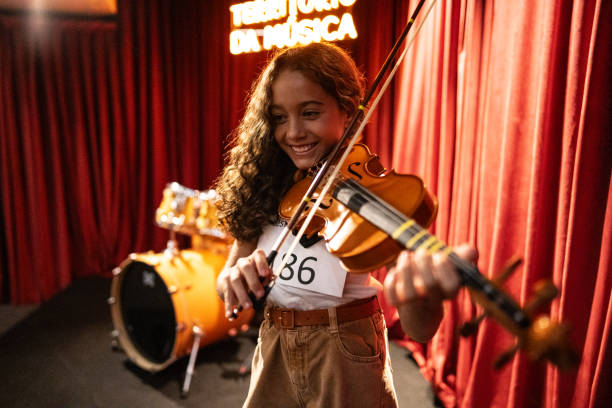 istock Girl playing violin in a music contest 1667842105