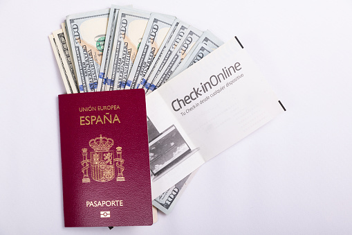 PLANE TICKET, CASH MONEY, SPANISH PASSPORT. HORIZONTAL. COLOR.