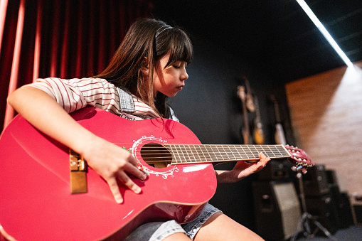 Girl playing guitar in a music contest