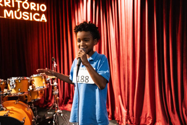 istock Boy singing in a music contest 1667871880