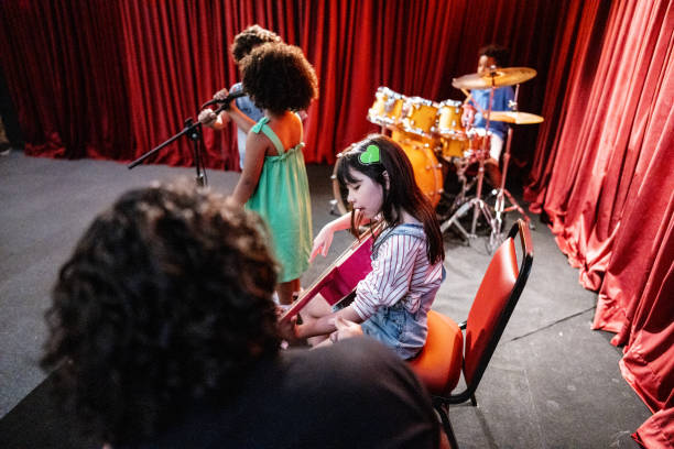 istock Girl playing guitar in a music school 1667873549