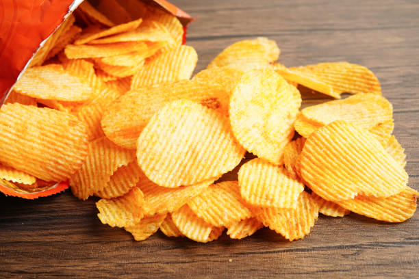 istock Potato chips in open bag, delicious BBQ seasoning spicy for crips, thin slice deep fried snack fast food. 1667874410