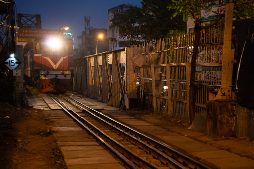 Train approaching at Ga Long Bien station at night, Hanoi ,Vietnam