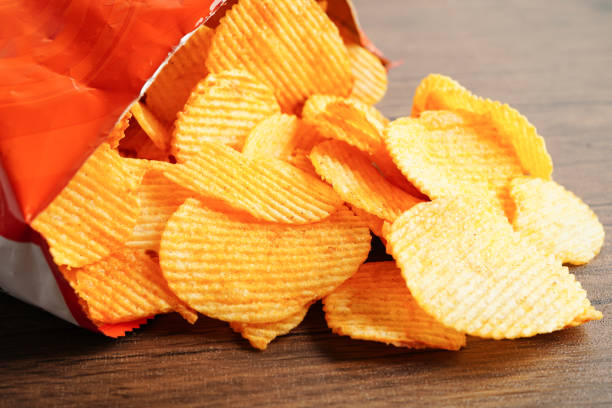 istock Potato chips in open bag, delicious BBQ seasoning spicy for crips, thin slice deep fried snack fast food. 1667874824
