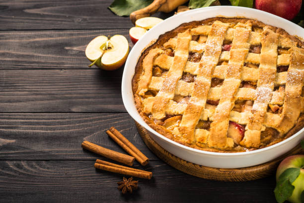 istock Apple pie with ginger and cinnamon at dark wooden table. 1667876074