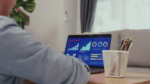 Businessman use a laptop for the business stock market, trading, infographic, charts, and data numbers insight analysis for the business meeting.