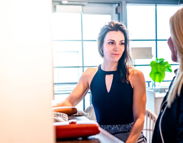 istock Two beautiful millennial age women sit at a bar or restaurant having a conversation 1667889679
