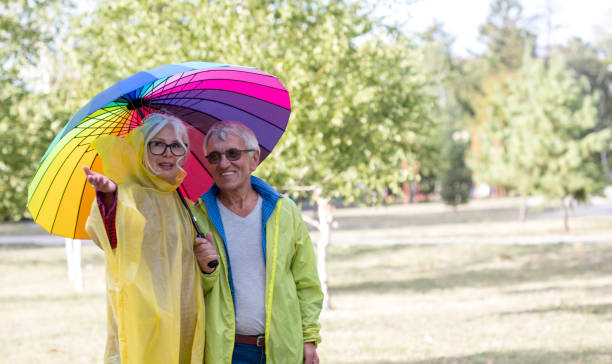 istock Couple under umbrella in autumn park 1667897916