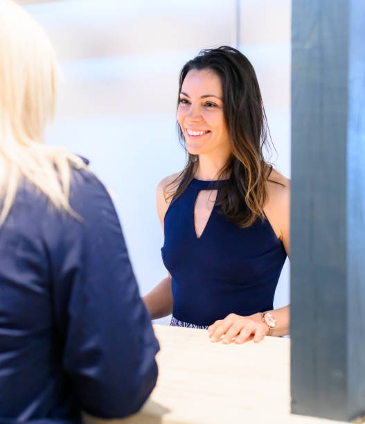 istock Woman at a counter takes an order or helps a customer 1667897924