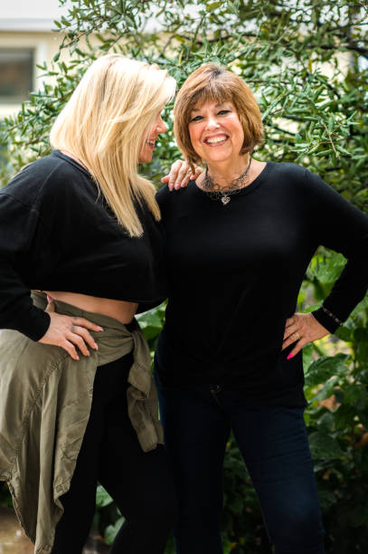 Mother and daughter, mature woman with her adult daughter in happy portrait stock photo