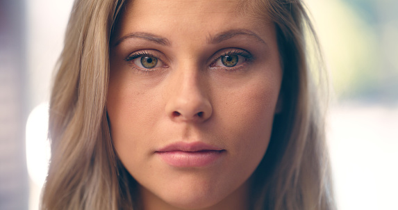 Closeup portrait and face of a woman in a house to relax with comfort, health and wellness. Serious, young model and head or headshot of a girl or person in a home for leisure, rest or looking