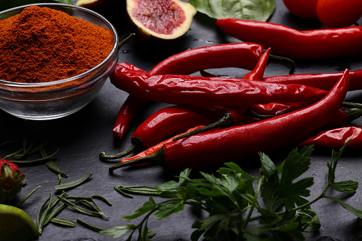 dry red chili in hand isolated on light background