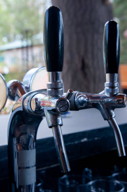 istock Pouring beer from keg, machinery. Professional serving beer 1667949447
