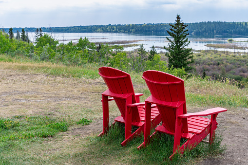 Red adirondack chairs in the park