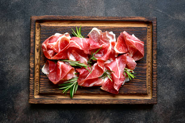istock Slices of prosciutto di parma or jamon serrano (iberico) . Top view with copy space. 1667962997