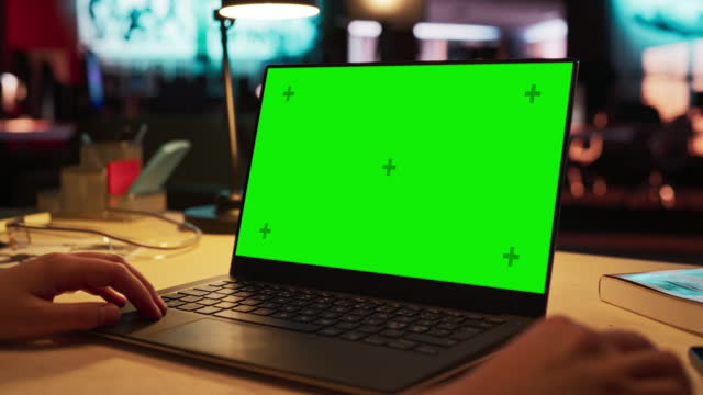 Close Up on Anonymous Designer Working on a Laptop Computer with Mock Up Green Screen Chromakey Display with Isolated Placeholder. Video Template for Artistic Content Creation and Presentations